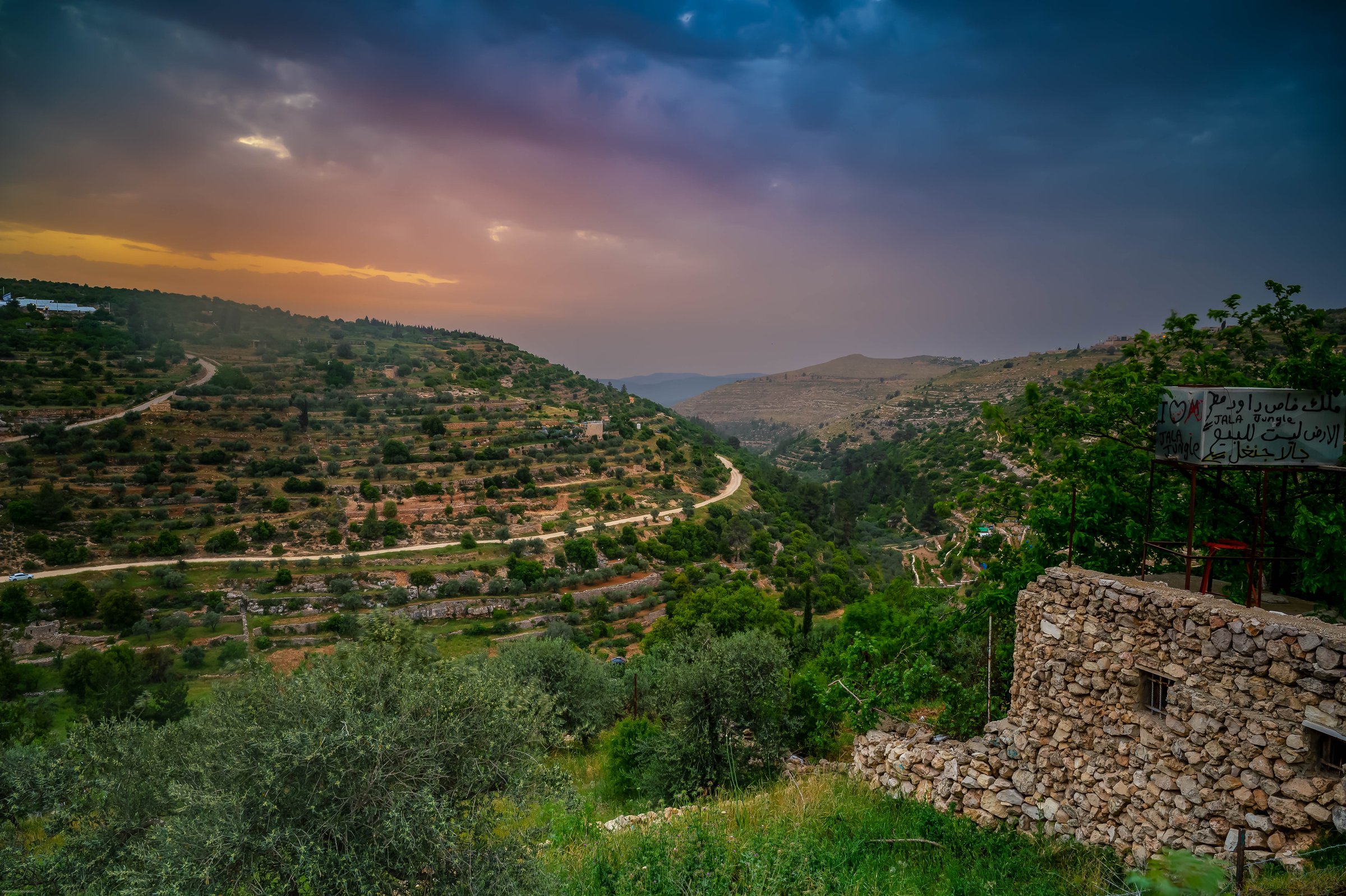 Terraced hillside near Bethlehem at dusk, stone building in the foreground